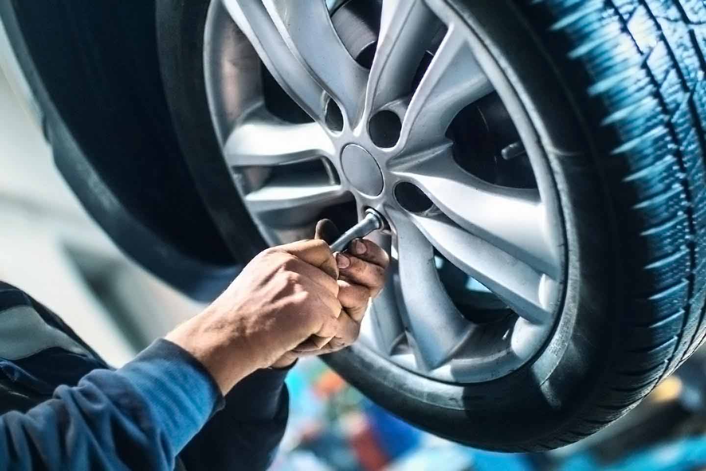 A professional service technician installing a brand new tire at Guaranty Chevrolet