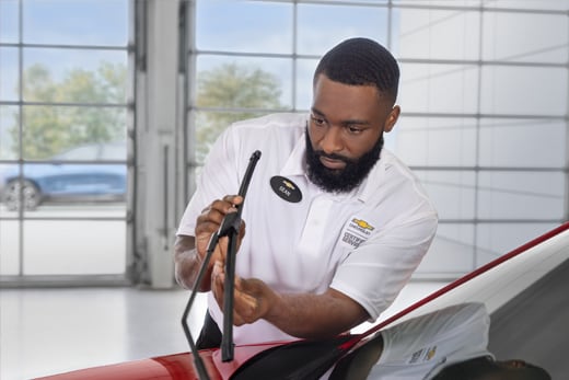 Technician putting on a new set of windshield wiper blades.