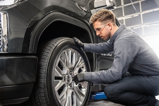 Technician putting on a new tire at Guaranty Chevrolet