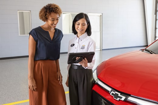 Customer reviewing their multi-point vehicle inspection report with their service advisor.