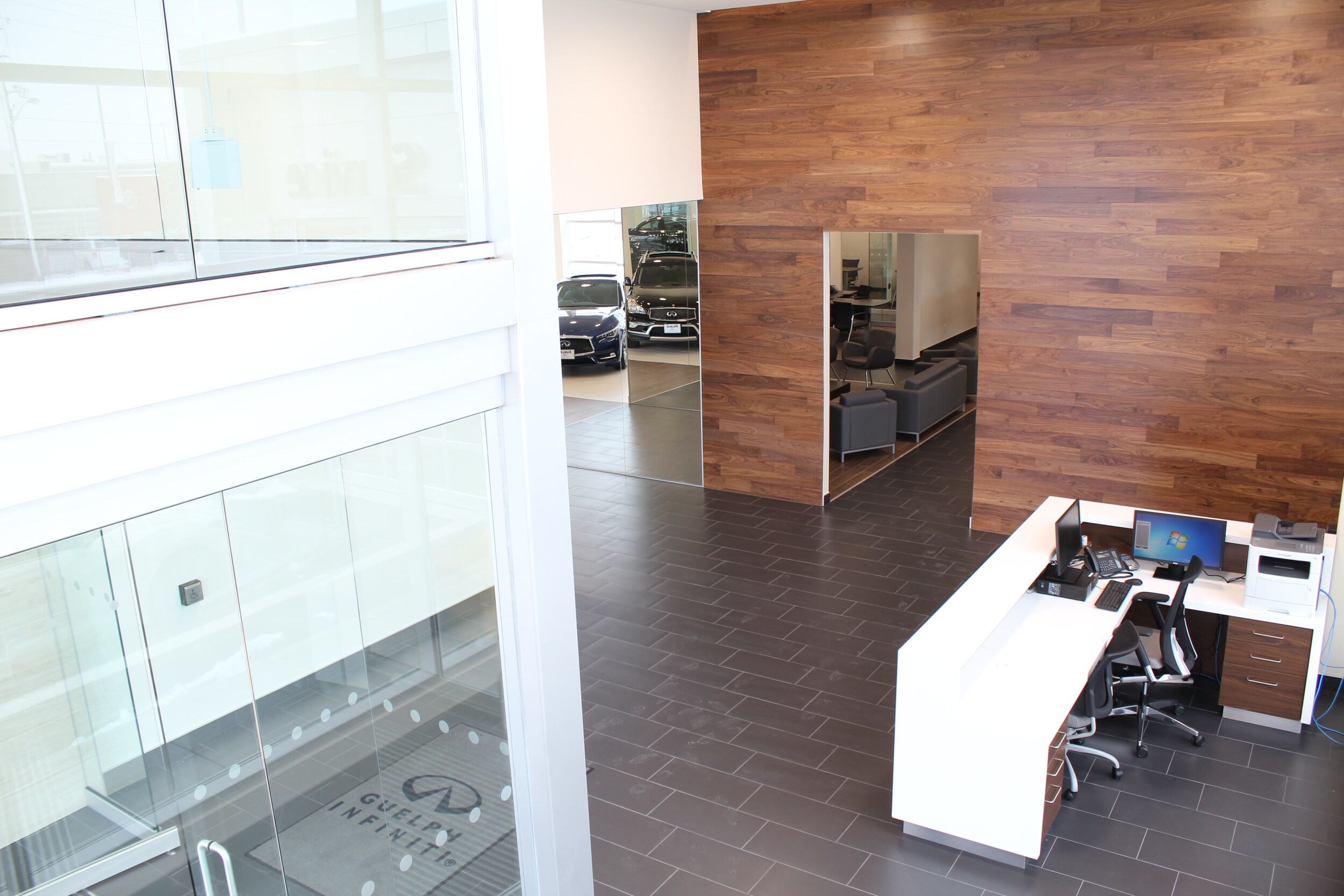 Guelph Infiniti Front Entrance - The front entrance invites you in with warm colours high celings and a concierge at the front desk to greet you as you enter on the right.