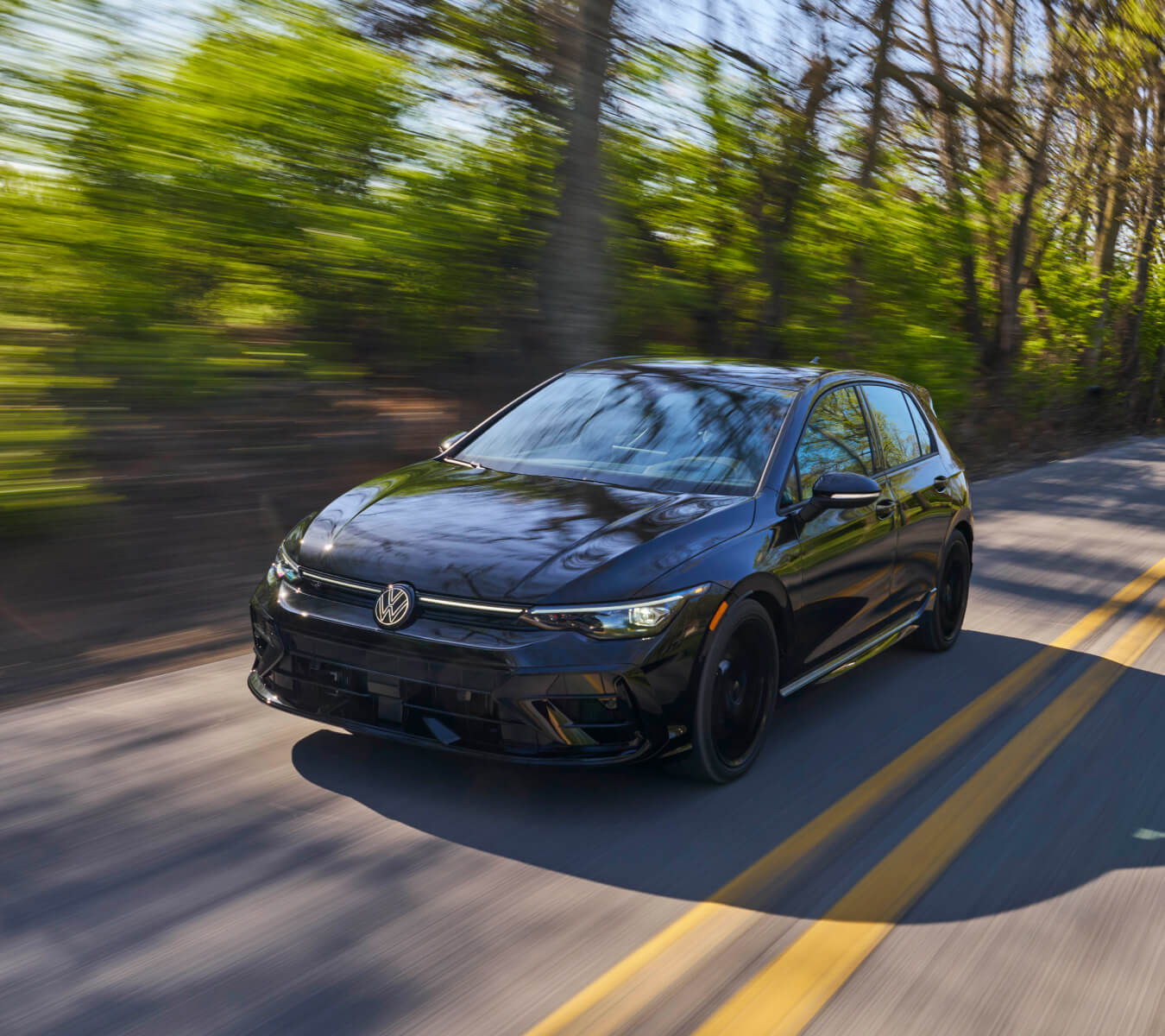 Volkswagen Golf R driving down a two lane road