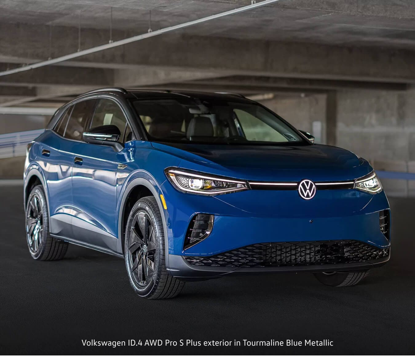 Volkswagen ID.4 Pro S Plus exterior in Mountain Lake Blue Metallic showing headlights in parking garage.