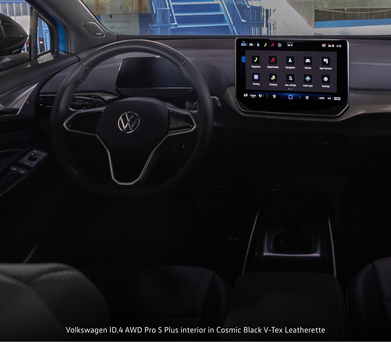 Volkswagen ID.4 Pro S Plus interior in interior in Black & Gray Leatherette (Galaxy) displaying central dashboard touchscreen from rear seats.