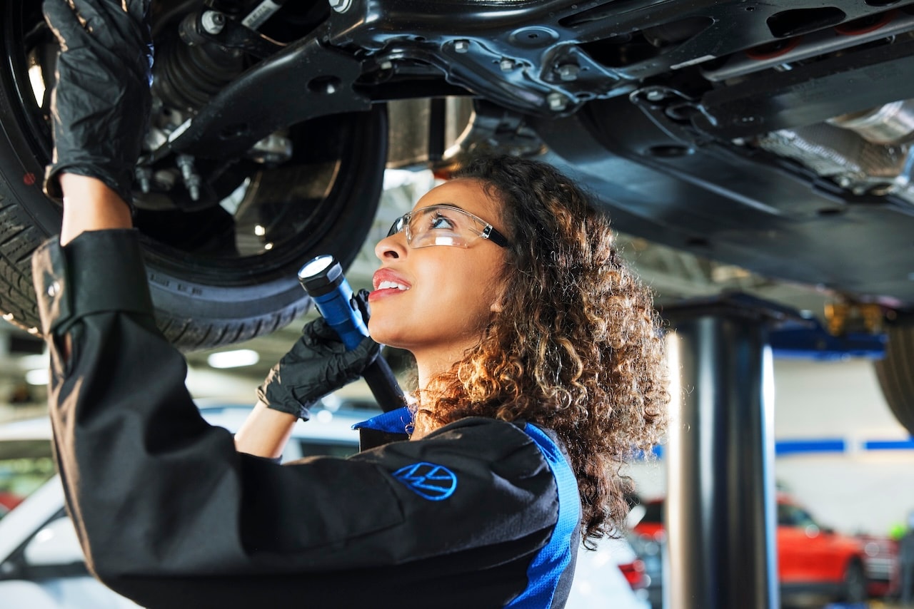 Volkswagen Technician working on a vehicle