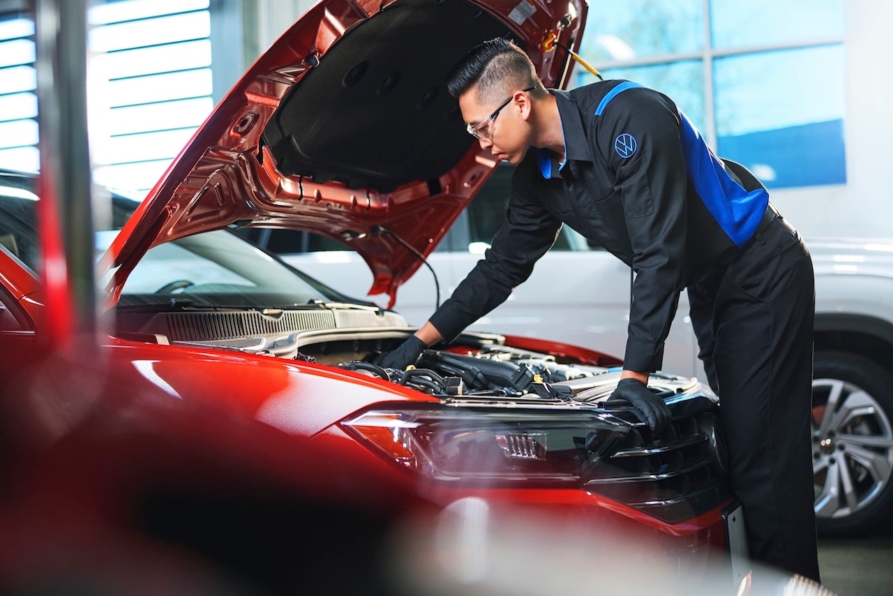 Volkswagen Technician working on a vehicle