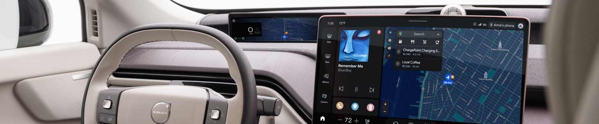 Interior view of 2027 Volvo EX60 dashboard in beige, featuring the steering wheel, digital cluster, and infotainment display.