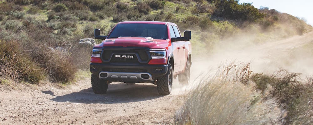 2019 Ram 1500 A red 2019 Ram 1500 driving down a dirt hill