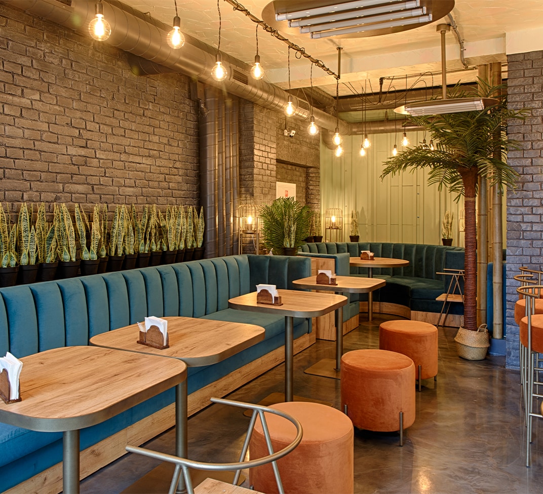 Haddad Hyundai Dealership near Great Barrington, MA | Interior of restaurant with orange seats and blue couch seats