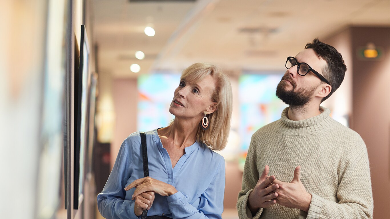 Haddad Hyundai Dealership near North Adams, MA | Man on the and a woman on the left are looking at a art peice against the wall 