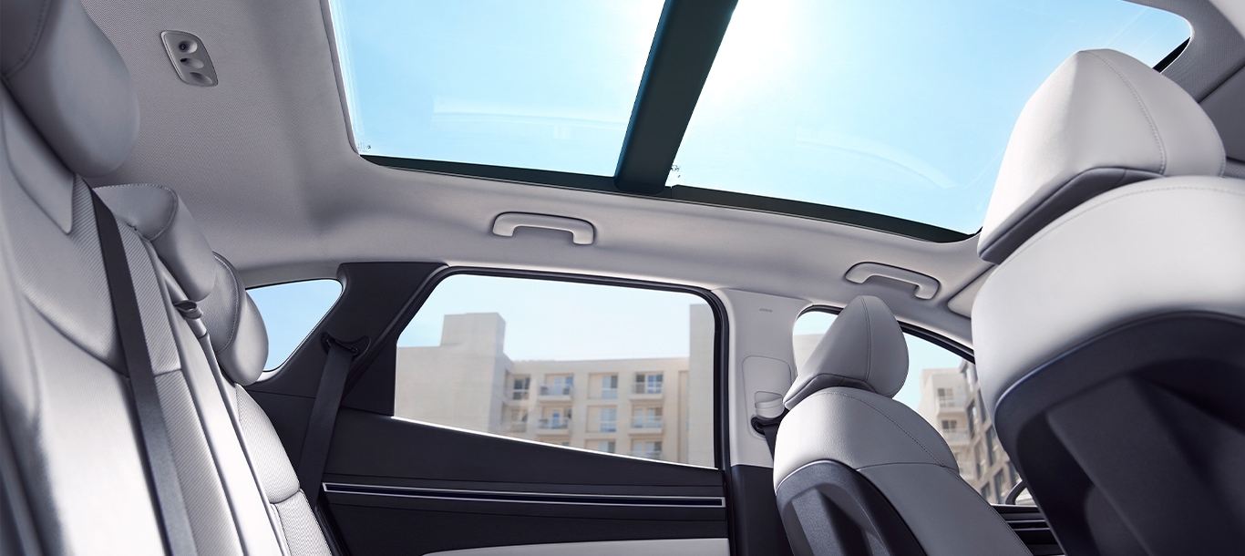  2023 Hyundai Santa Fe at Haddad Hyundai | Woman and kids smiling and laughing inside of a 2023 Santa Fe
