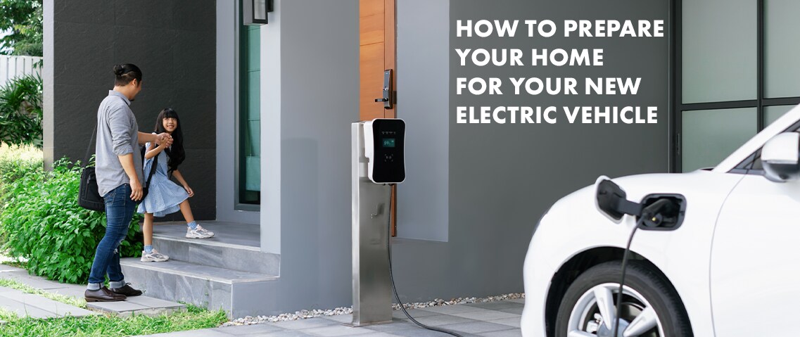 How to prepare your home for your new Electric Vehicle at Haddad Toyota in Pittsfield, MA | Dad and daughter walking into home while their white electric car is charging outside 