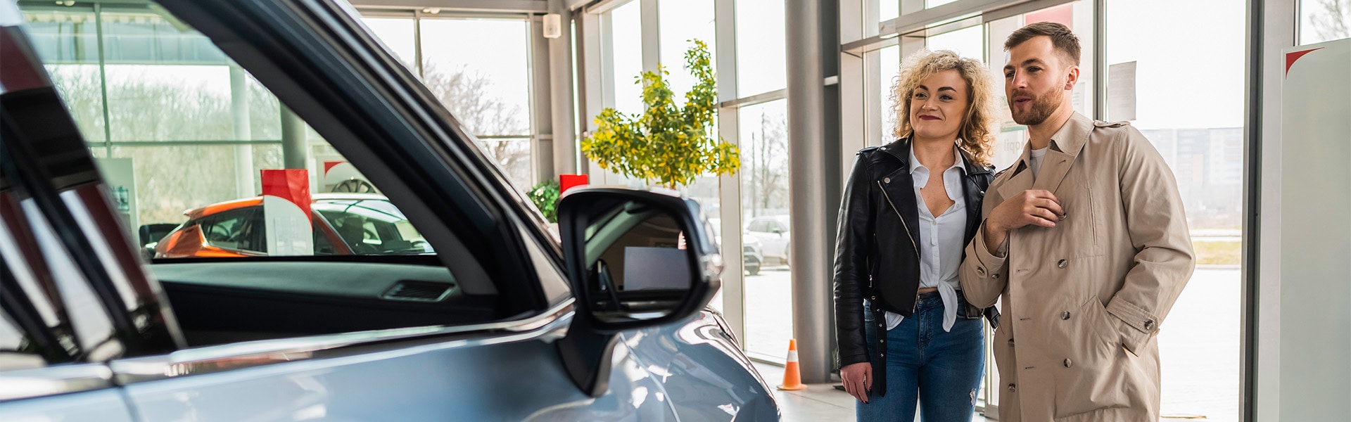 Haddad Toyota is a Toyota Dealership near Pittsfield, MA | Couple Looking at Car on Sales Floor of Car Dealership