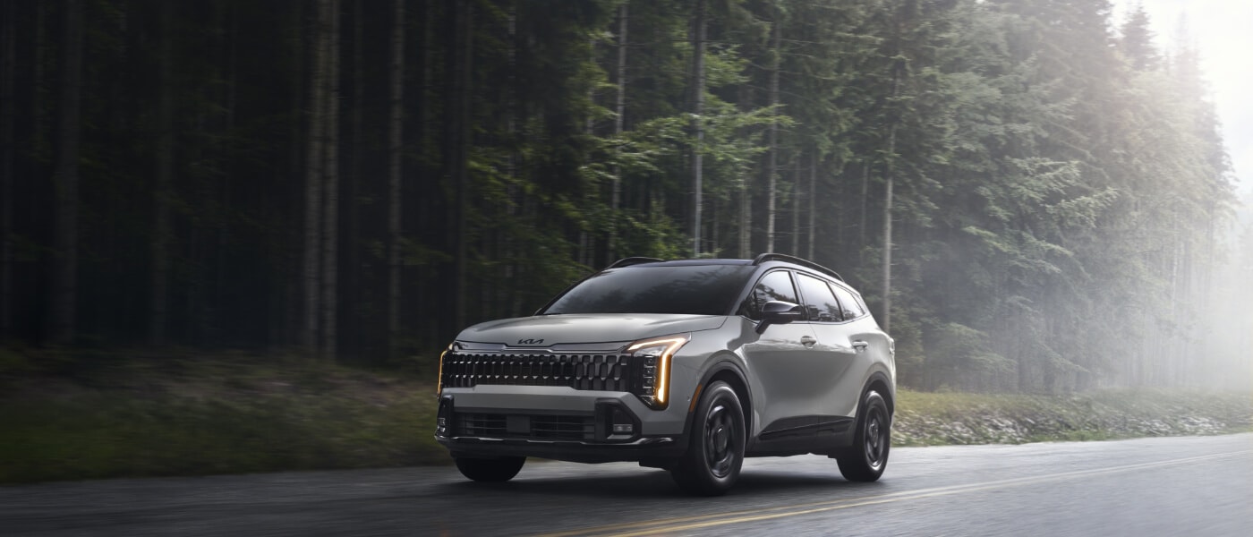 2026 Kia Sportage Exterior Driving On Forest Road