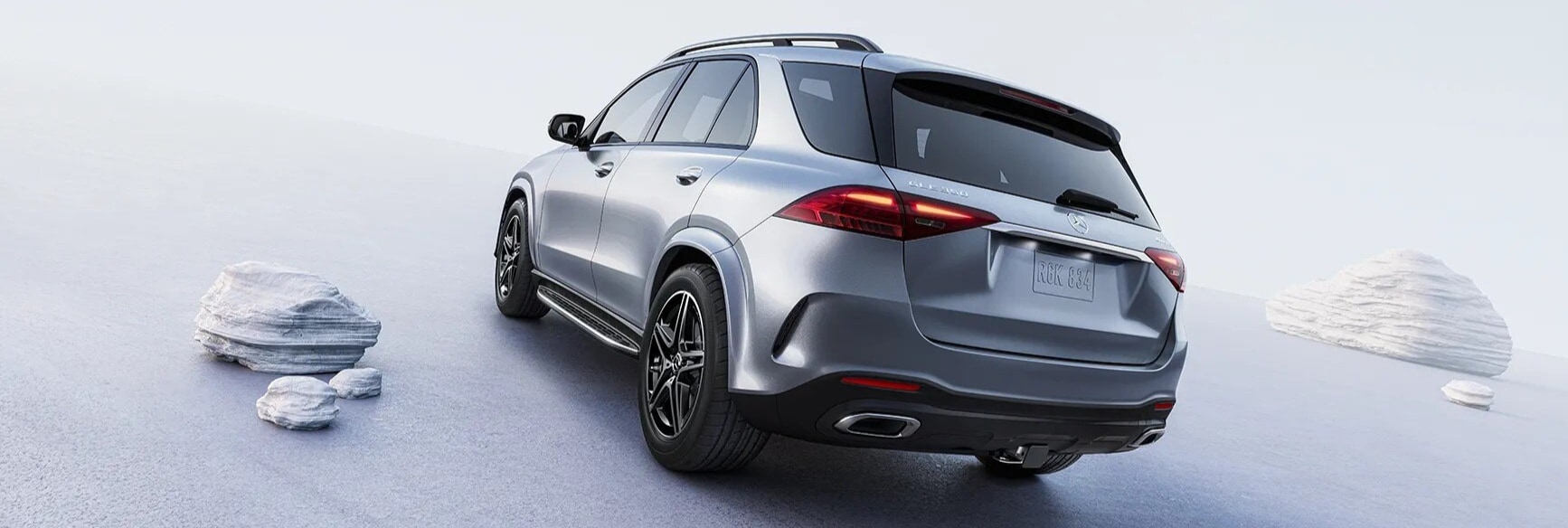 Silver Mercedes-Benz GLE 350 AMG driving on a road in the desert