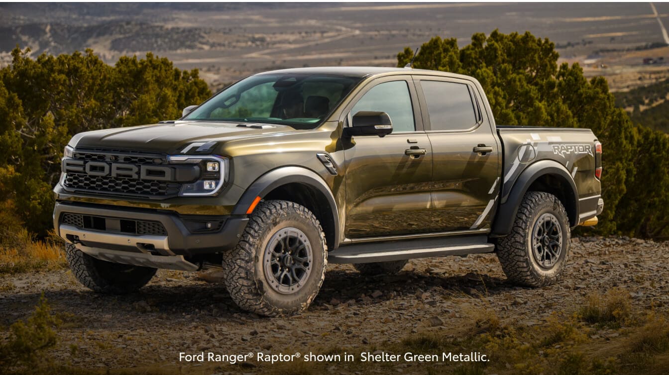Three-quarter view of a 26 Ford Ranger Raptor climbing a rocky off-road ridge in a high-desert.