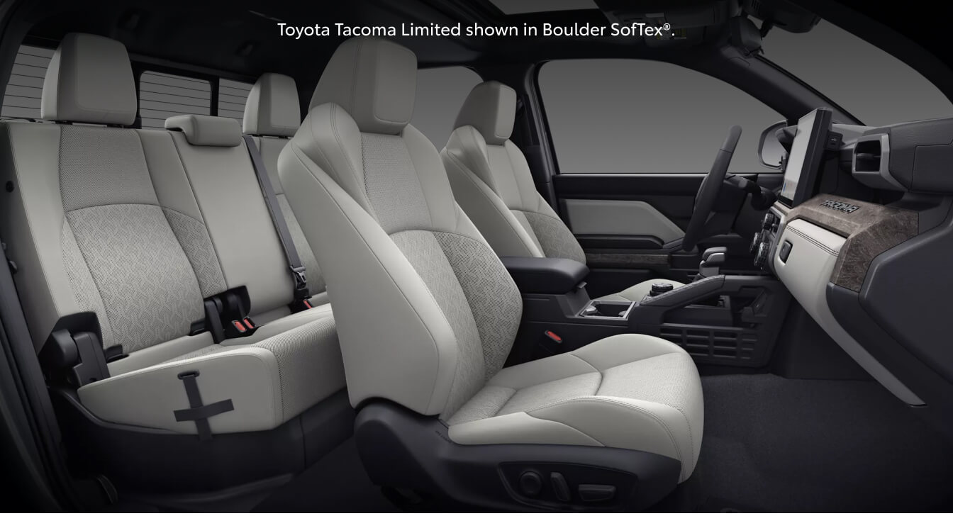 Studio interior view of a 26 Toyota Tacoma Limited showcasing patterned light gray Boulder SofTex seats.