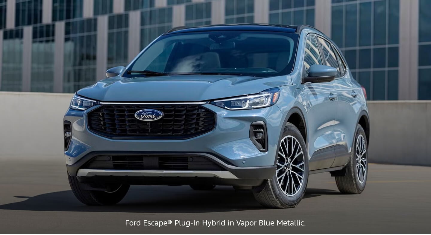 Three-quarter front view of a blue Ford Escape Plug-In Hybrid parked on a parking deck.
