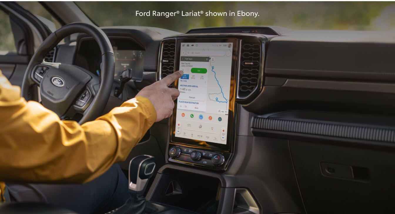 Close-up interior dashboard view of a 26 Ford Ranger Lariat as a driver operates the touchscreen.