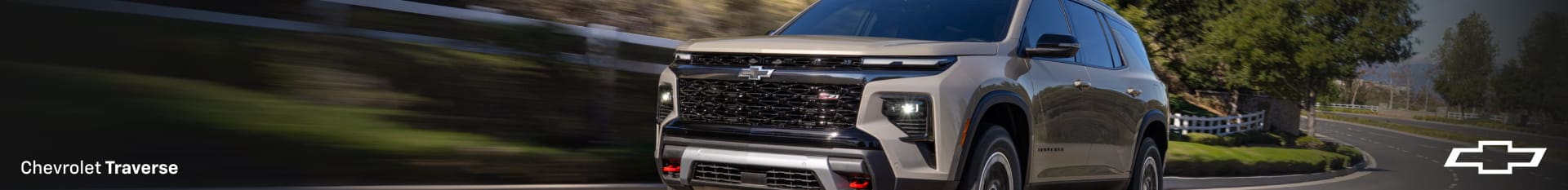 Chevrolet Traverse traveling down a road.