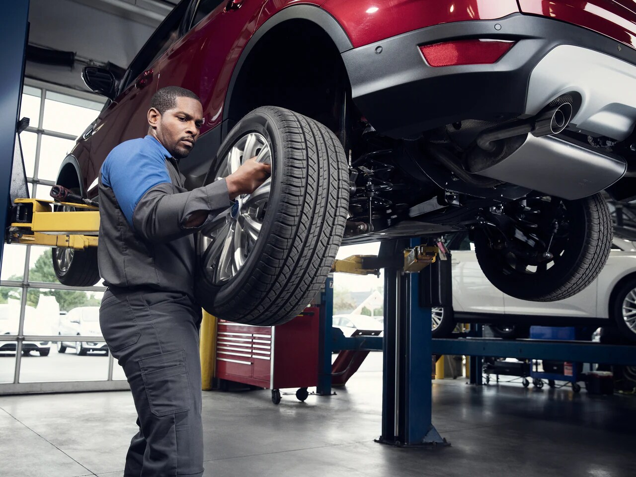 Ford Service Technician installs tires in a Ford Service center