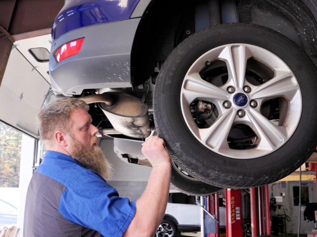Ford Technician at Haley Ford Inspects Vechie's Tires