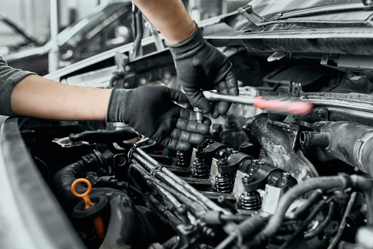 Technician Replacing Spark Plugs.png