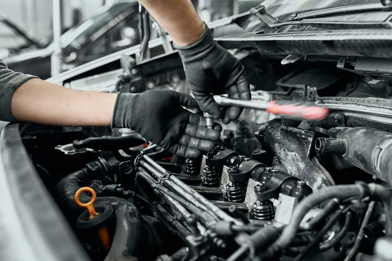 Technician Replacing Spark Plugs.png