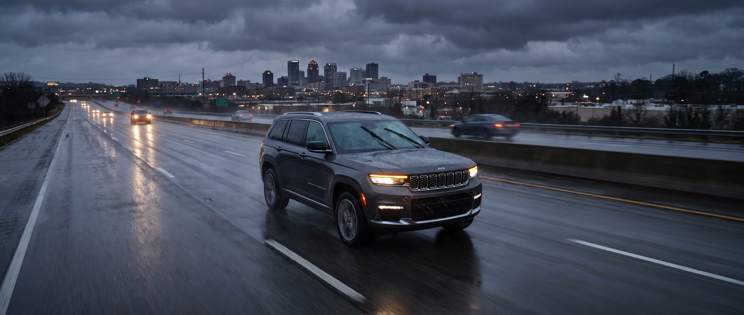2026 Jeep Grand Cherokee on wet Birmingham interstate bypass in summer storm conditions