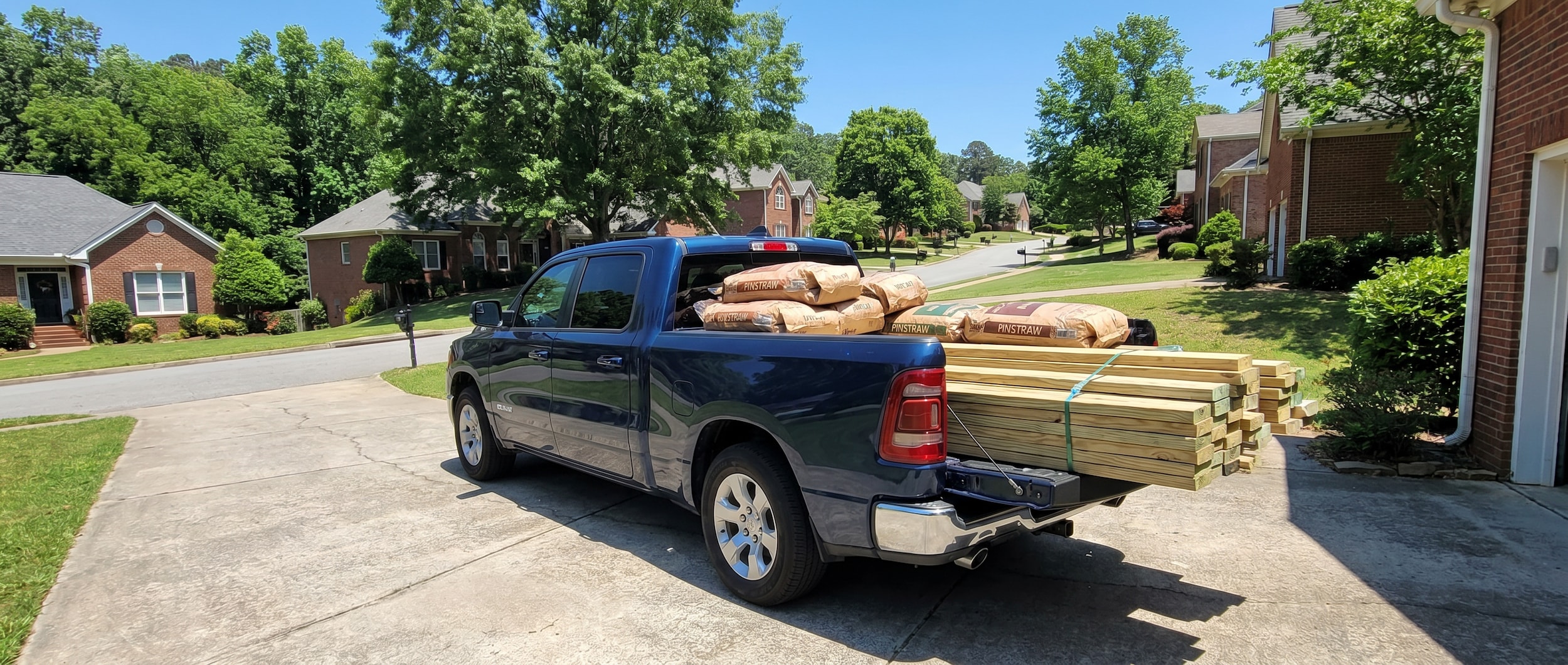 2026 Ram 1500 loaded with lumber in Birmingham driveway during summer home project season