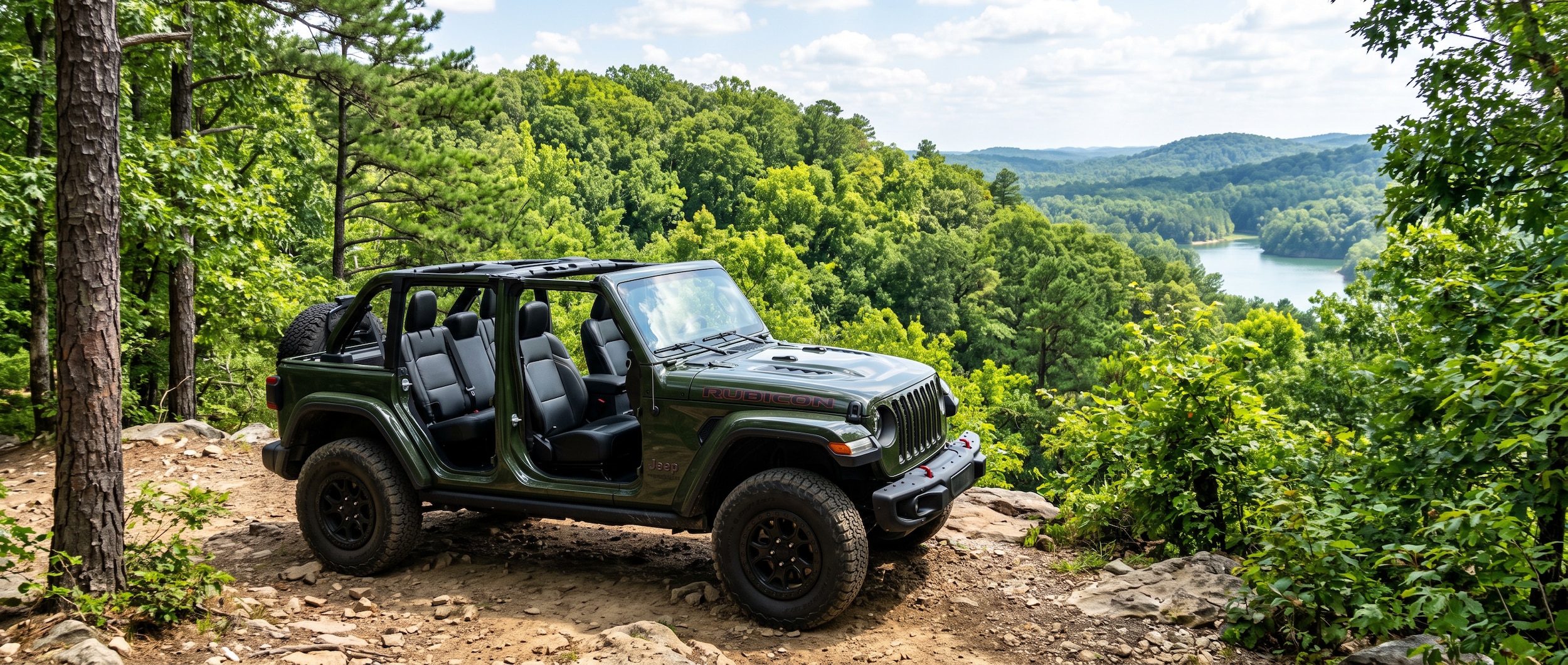 2026 Jeep Wrangler Unlimited with doors off on a forested ridge trail at Oak Mountain State Park, Alabama, late summer