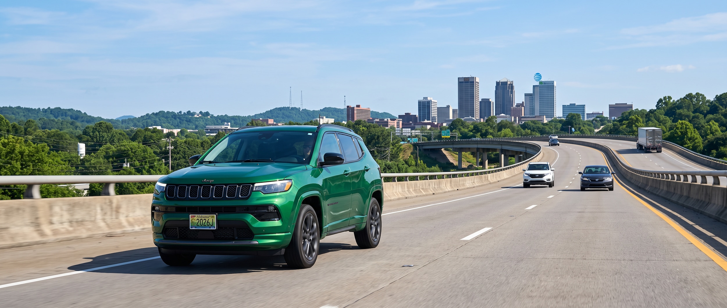 2026 Jeep Compass driving southbound on I-65 toward downtown Birmingham on a clear July morning