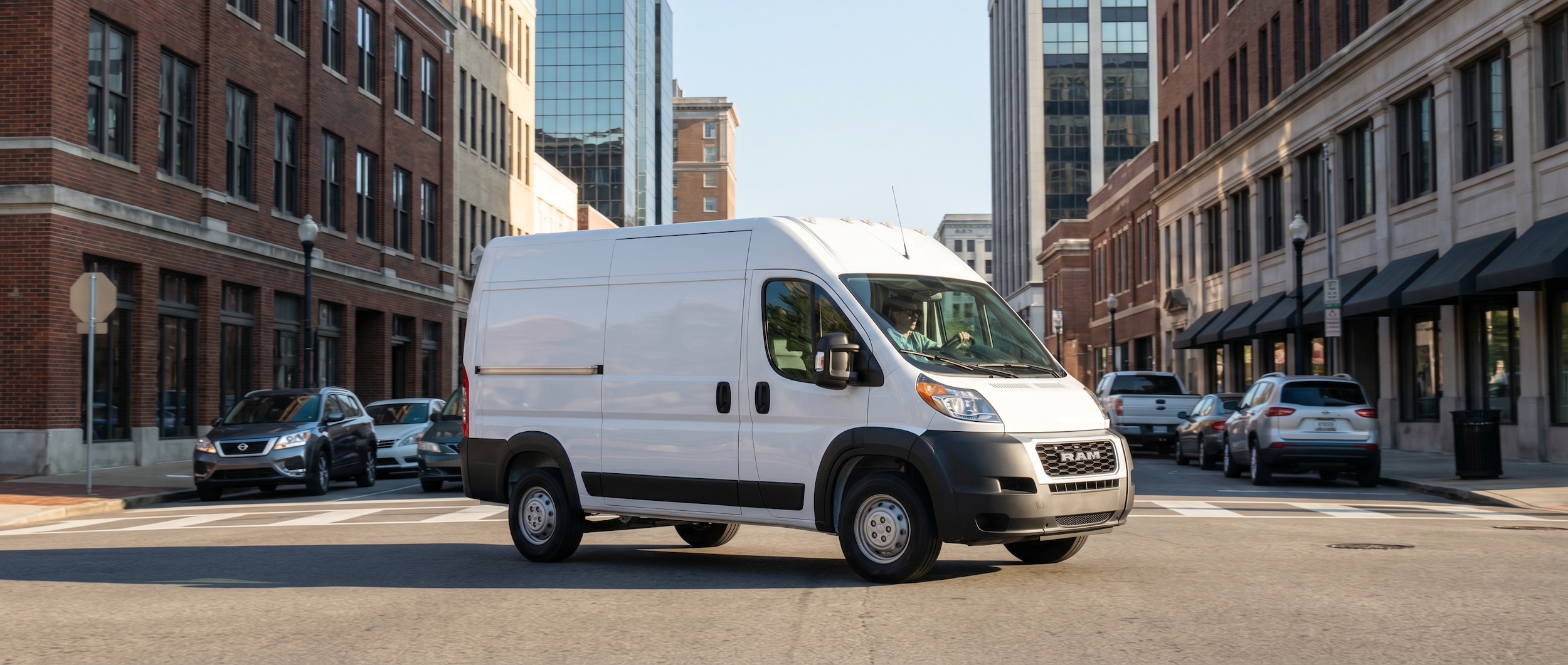 RAM ProMaster delivery van navigating downtown Birmingham AL streets