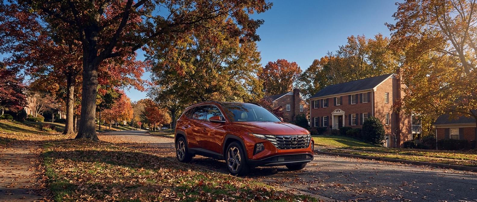 2026 Hyundai Tucson Hybrid parked on a fall afternoon in a Vestavia Hills neighborhood with autumn foliage