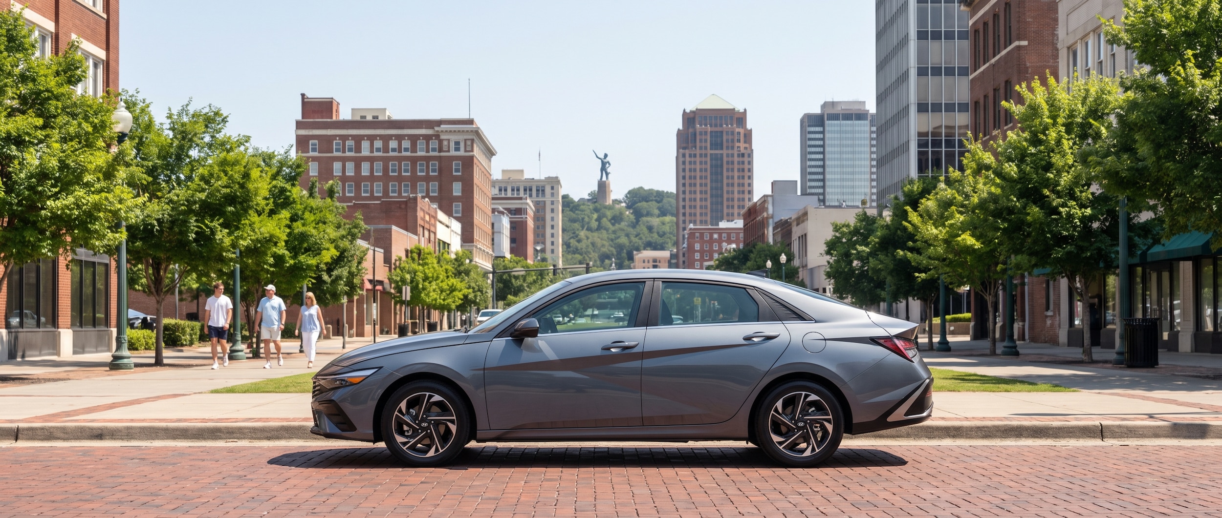 2026 Hyundai Elantra Hybrid on a downtown Birmingham street with the city skyline in the background
