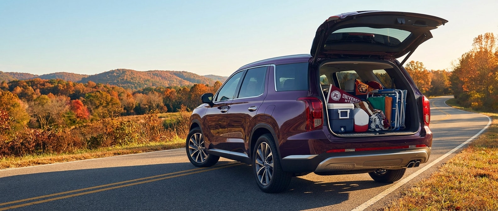 2026 Hyundai Palisade Hybrid loaded for an Alabama football road trip from Birmingham with cargo area open on a scenic Alabama highway