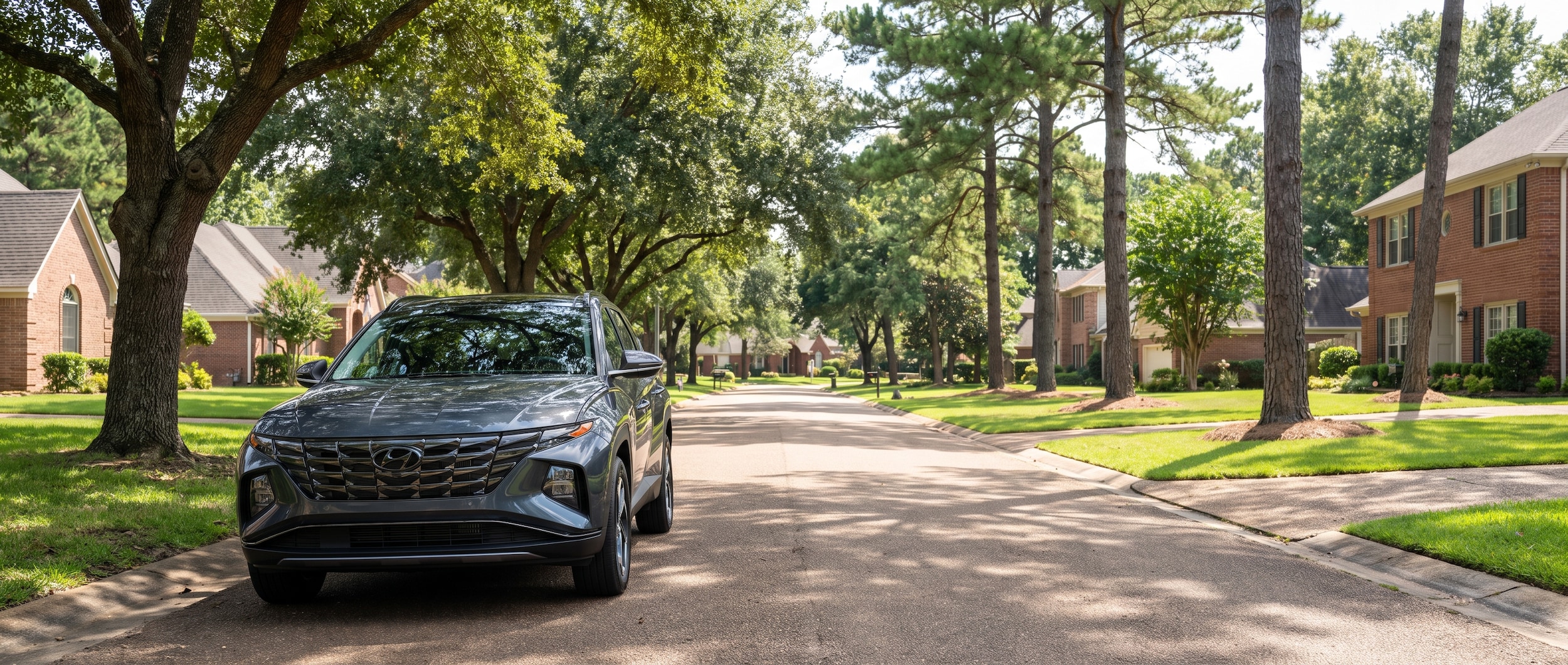 2023 Hyundai Tucson Hybrid parked on a tree-lined suburban road in Ridgeland, Mississippi
