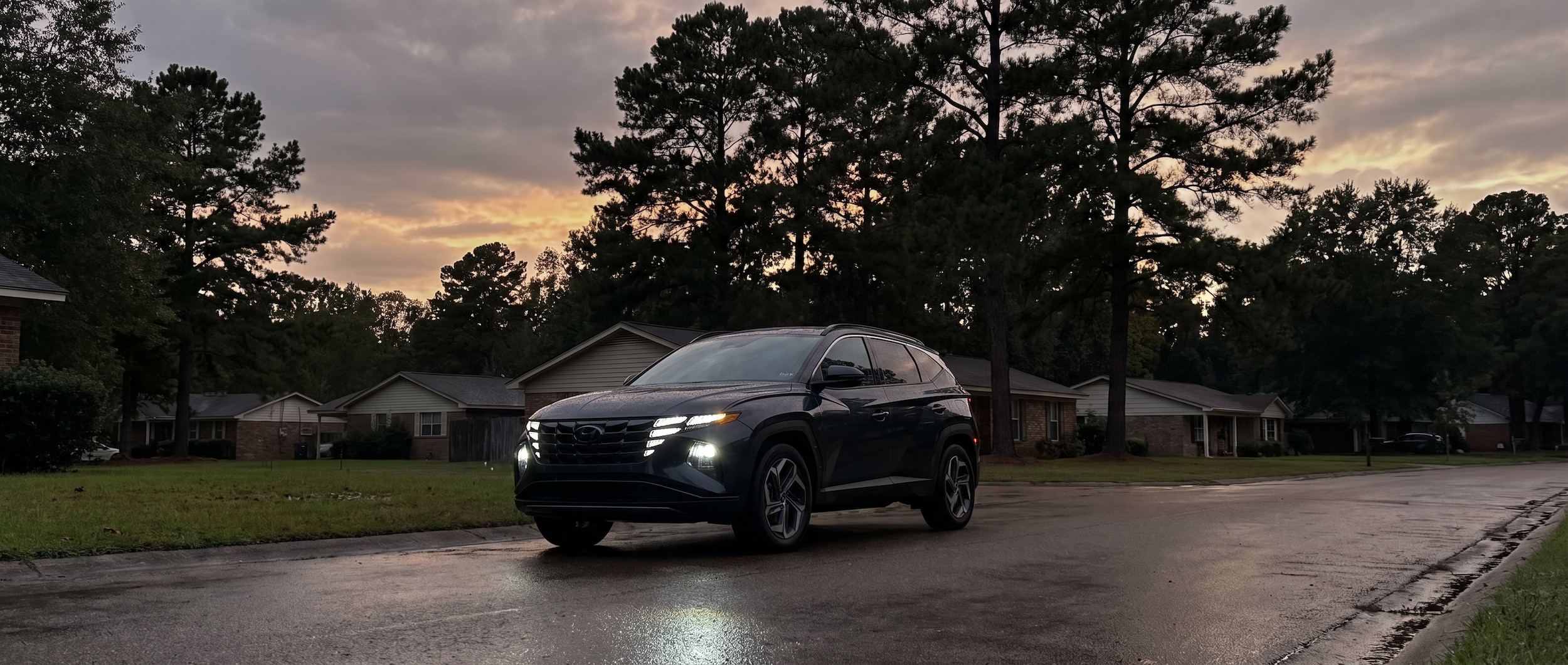 2026 Hyundai Tucson with LED headlights on at dusk in Ridgeland Mississippi fall evening