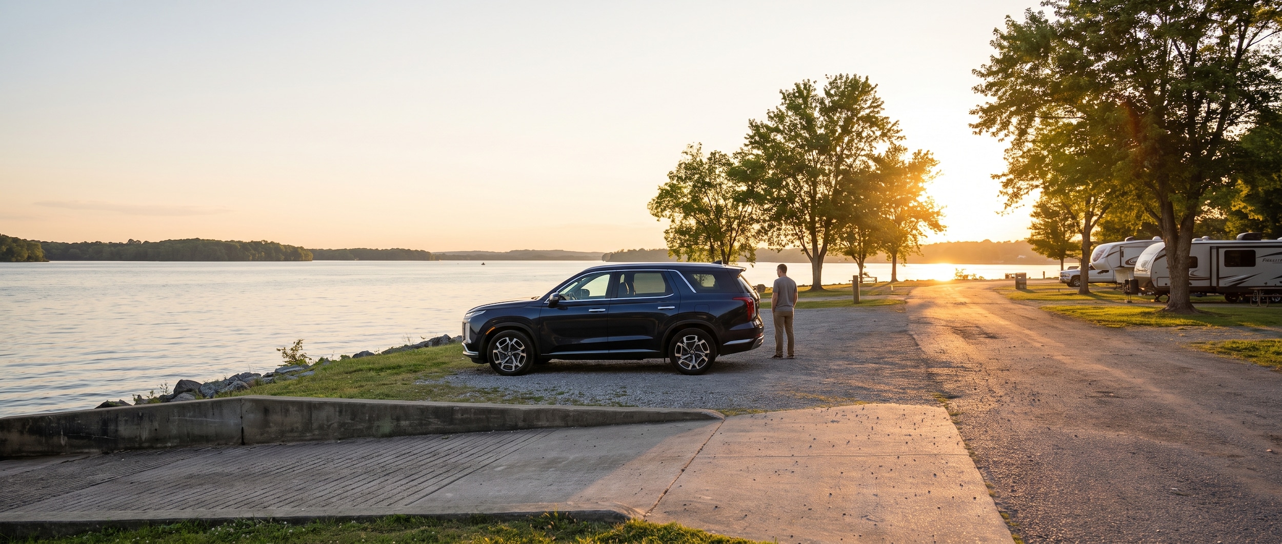 A 2023 Hyundai Palisade in deep blue parked at the edge of Old Hickory Lake at golden hour, a boat ramp and tree-lined campground lane in the background, Hendersonville Tennessee summer setting
