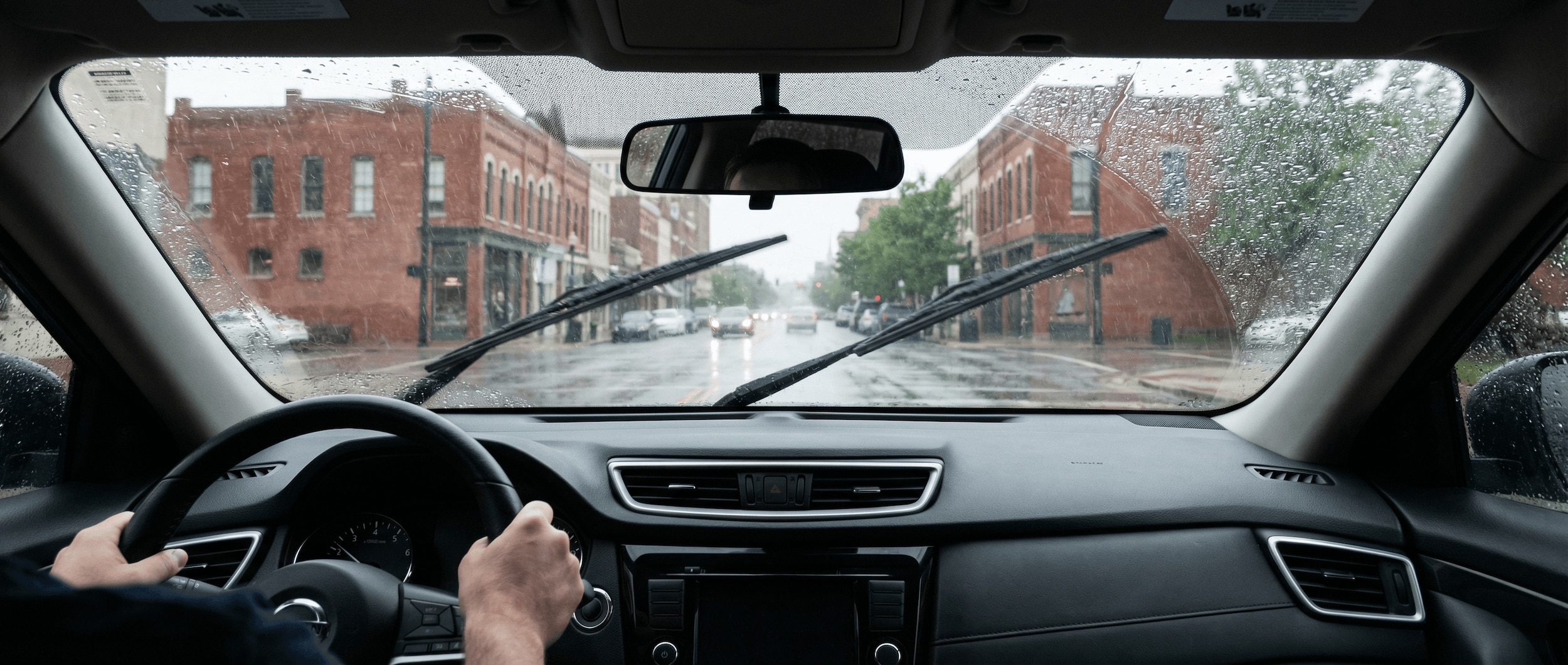 Nissan windshield wipers clearing rain on Birmingham AL streets