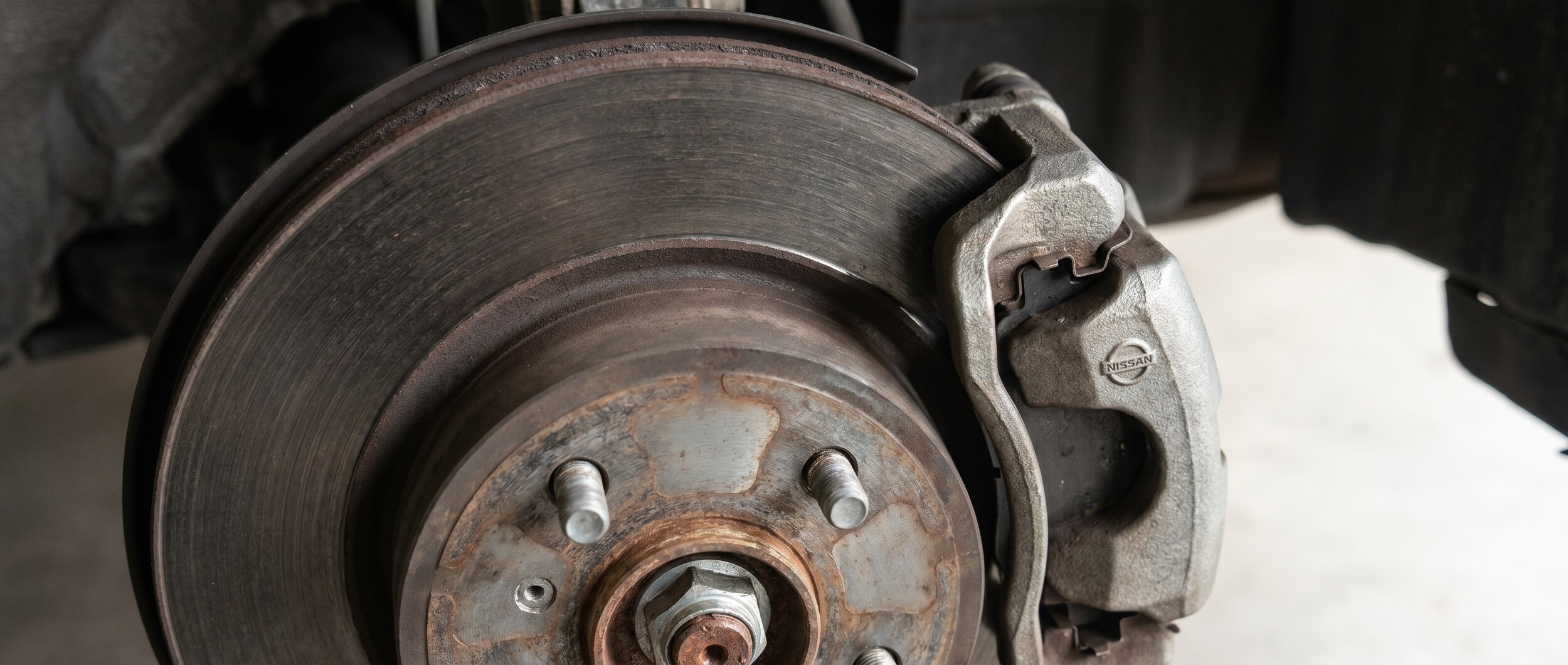 Brake rotor and pad components on Nissan vehicle in Birmingham AL