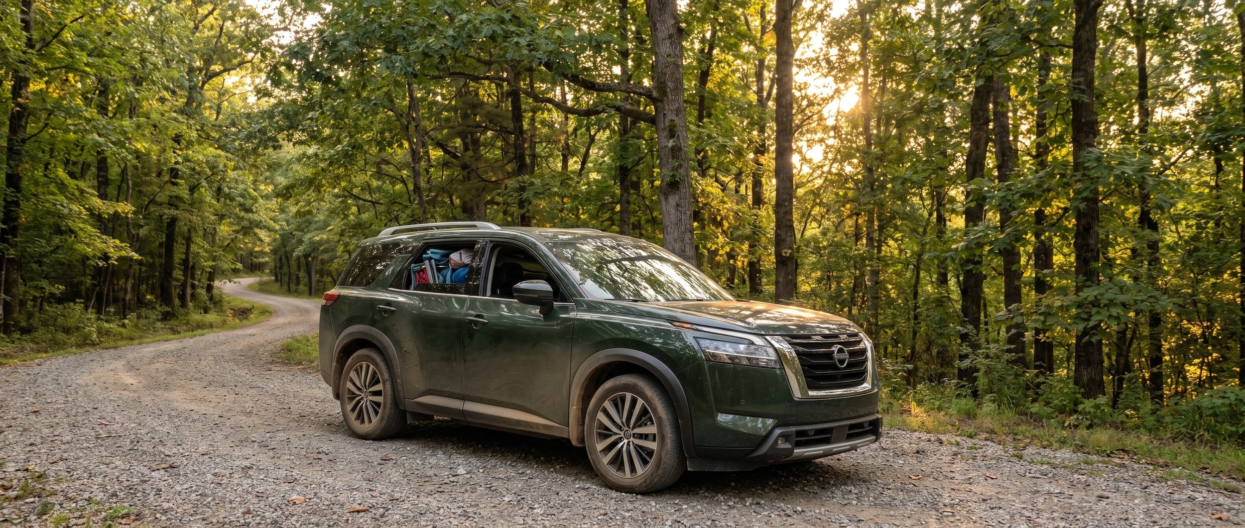 2026 Nissan Pathfinder on a gravel access road at a forested Alabama state park