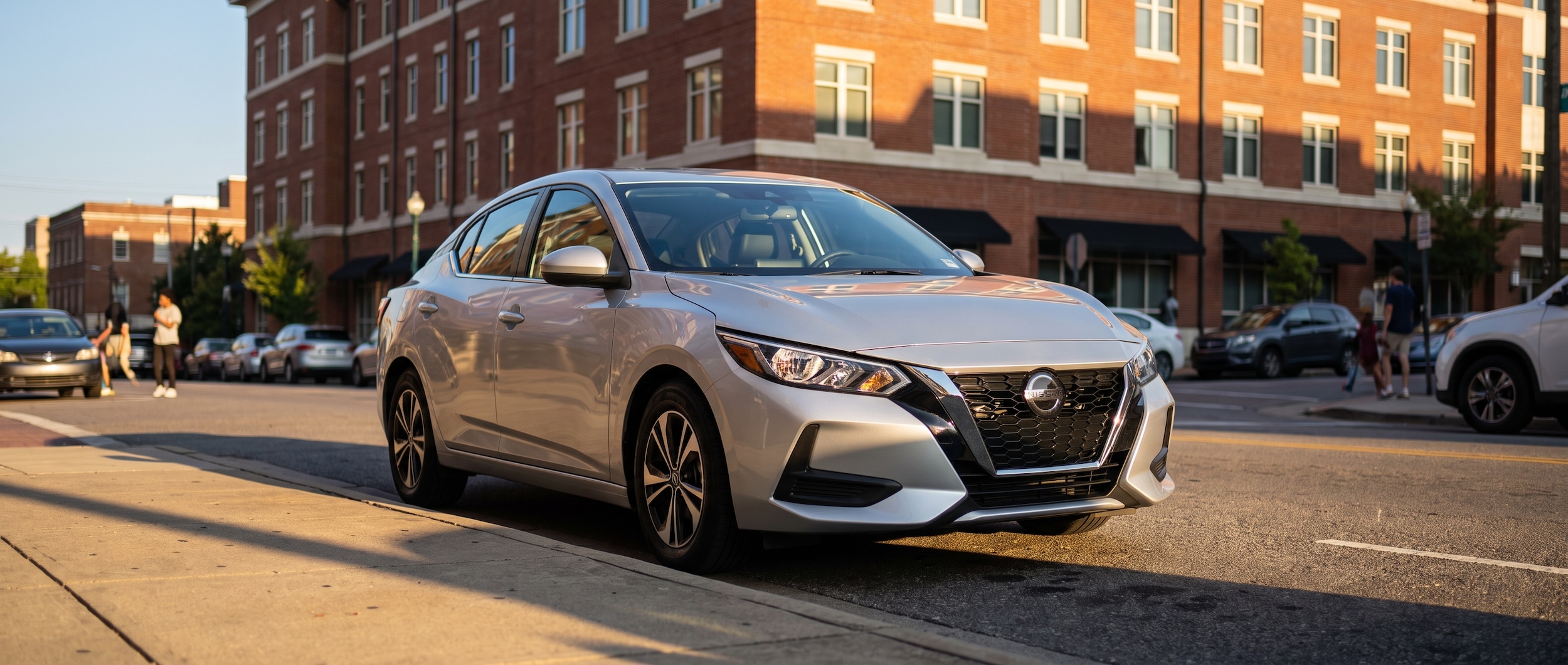 2023 Nissan Sentra parked near a Birmingham university campus building, used compact sedan for students