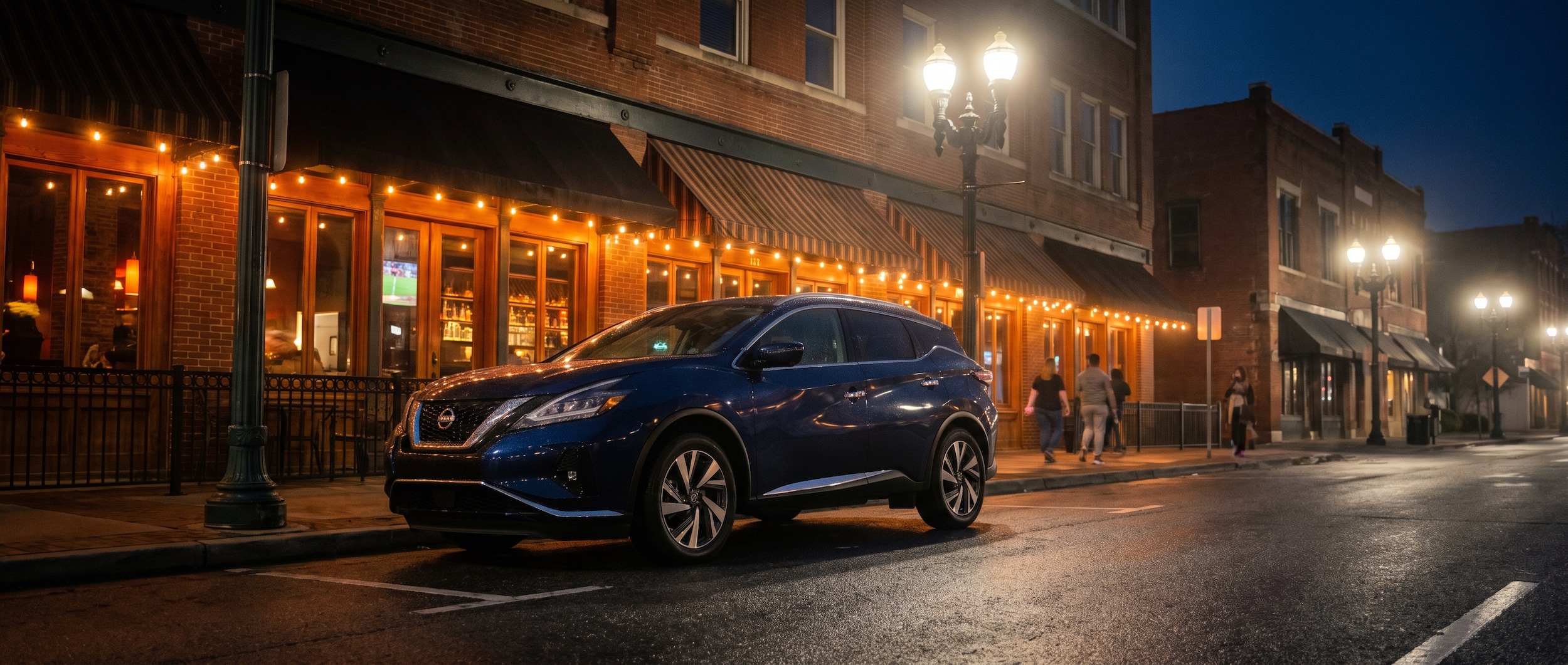 2026 Nissan Murano parked on a downtown Birmingham street at night during a summer food tour evening