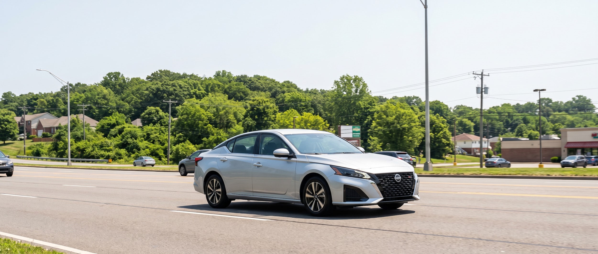 2026 Nissan Altima on a multi-lane Birmingham Alabama surface road in summer