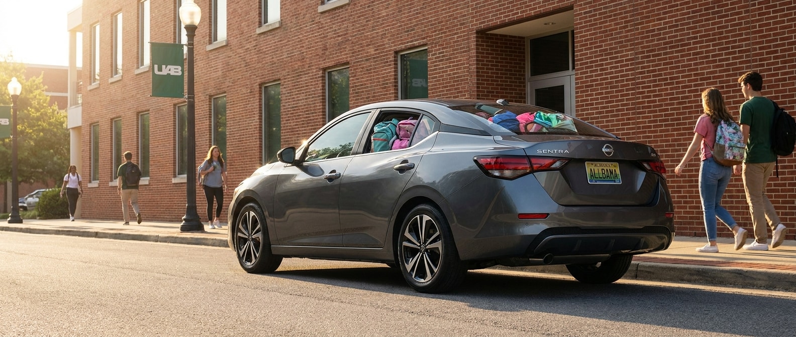 2026 Nissan Sentra parked near a Birmingham Alabama university campus building on a bright August afternoon