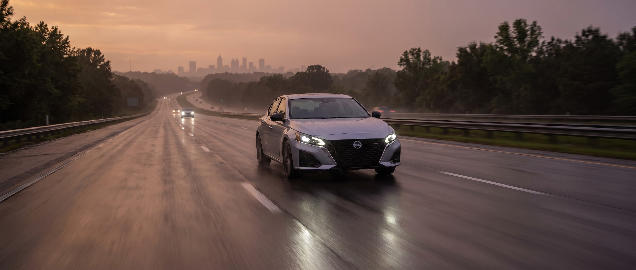2026 Nissan Altima on a wet Birmingham Alabama interstate highway at dusk