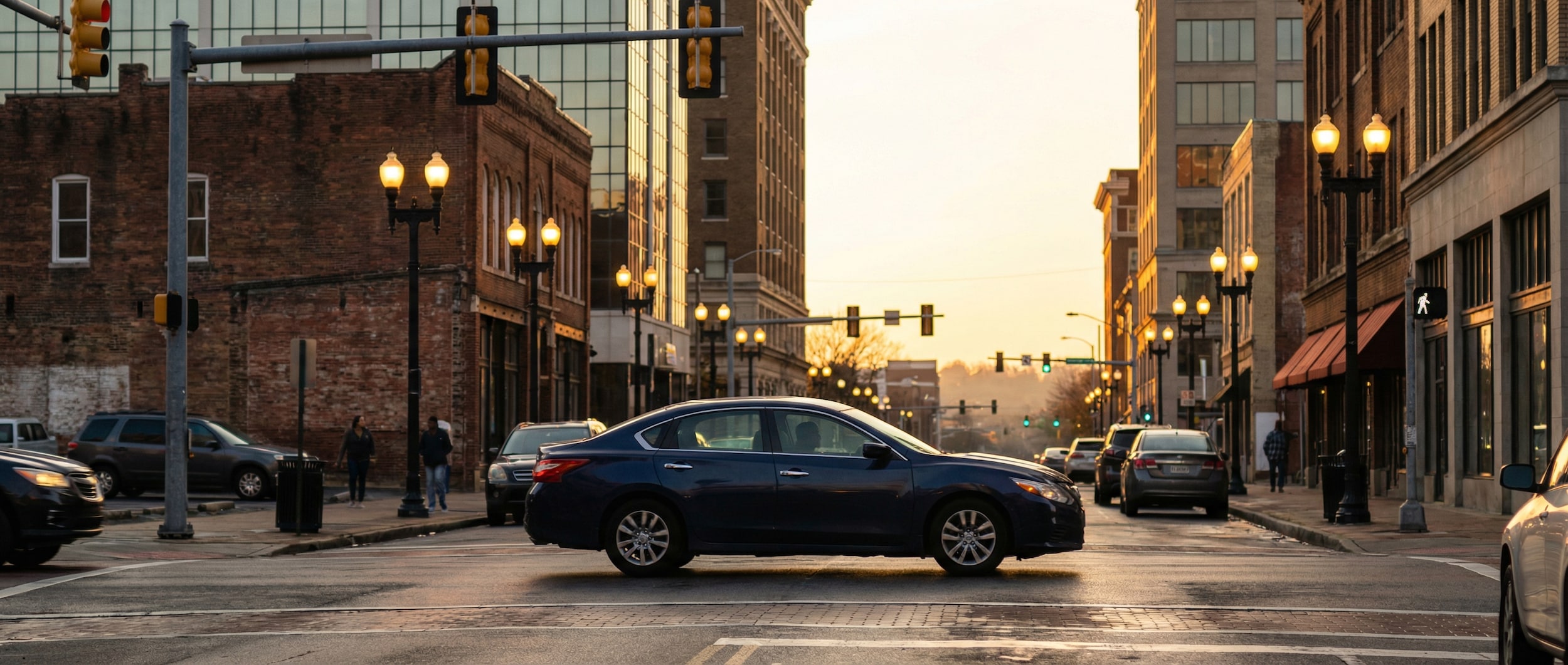 Nissan Altima fuel-efficient driving through downtown Birmingham AL traffic