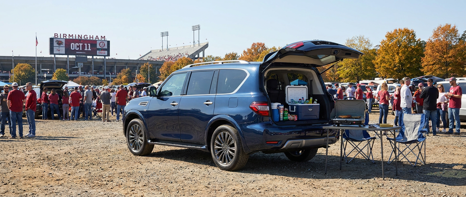2026 Nissan Armada rear liftgate open at a Birmingham stadium tailgate with gear loaded in the cargo area