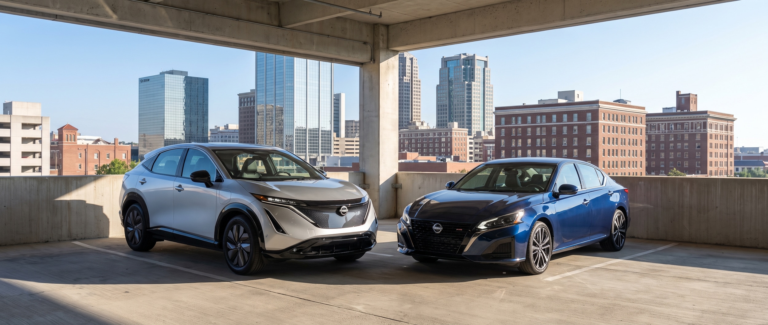 2026 Nissan LEAF and 2026 Nissan Altima parked side by side in Birmingham AL parking garage